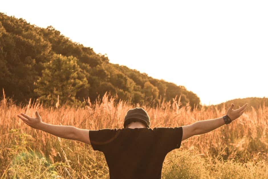 man embracing life with open arms